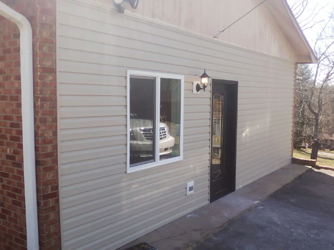 New vinyl siding and entry door on a room addition in Colquitt